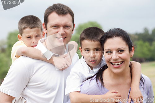 Image of Beautiful couple carrying their kids on their back