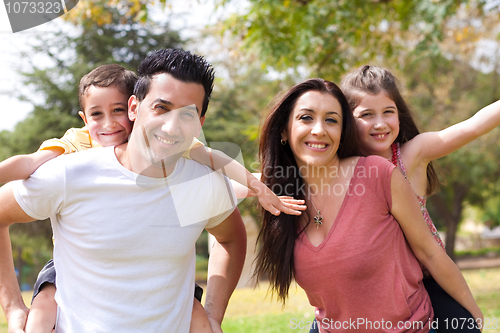 Image of Children enjoying and playing on their parents shoulders