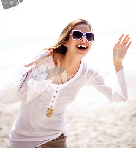 Image of Happy young woman having fun at the beach