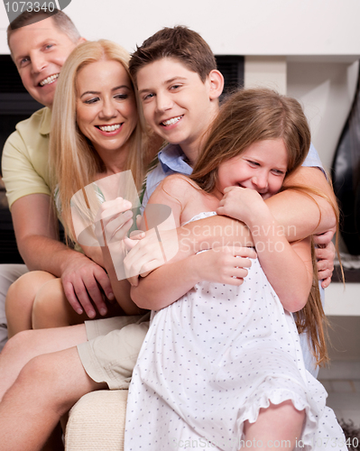 Image of Happy family sitting in straight and having fun