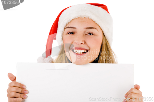 Image of Women with santa cap smiling and holding a blank board