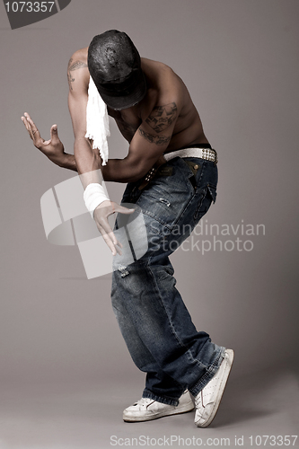 Image of Dancer with spider tatoo on his chest performing dance