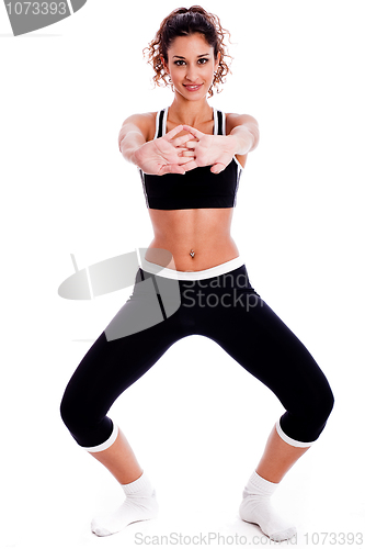 Image of Cute fitness girl stretching her hands