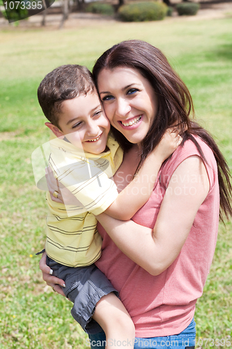 Image of Cute kid with white dress sitting on her mom