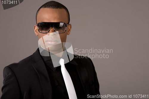 Image of Ethnic young business man wearing sunglasses