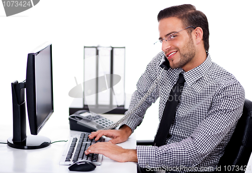 Image of Busy professional using telephone while at work