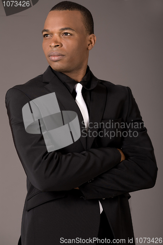 Image of Young black american business man with folded hands