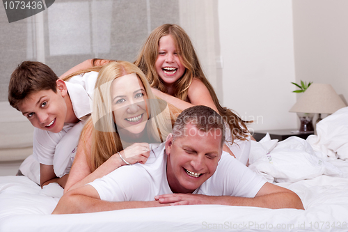 Image of Family having fun in bed