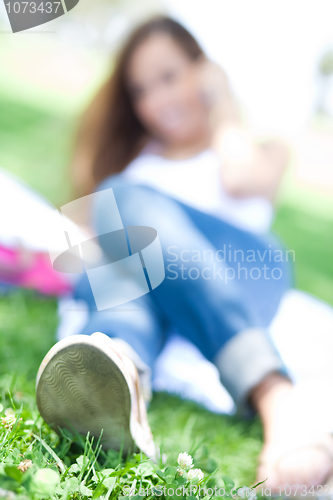 Image of Blur image of a Young women lying in the park