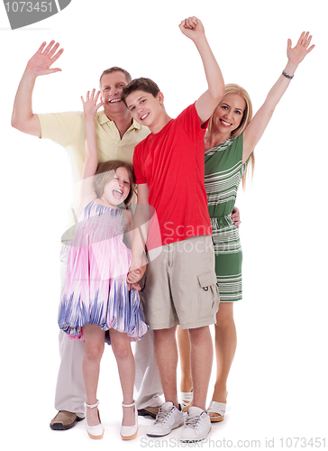 Image of Happy family raising their hands and having fun