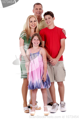 Image of Happy family of four standind and looking at you