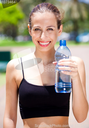 Image of Smiling fitness woman with water bottle