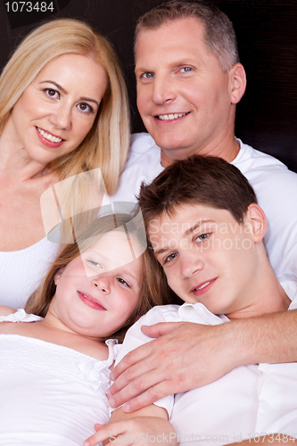 Image of Portrait of happy family posing towards the camera