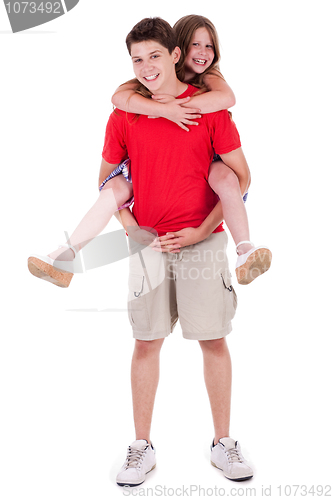 Image of Loving brother gives piggyback to his beautiful sister