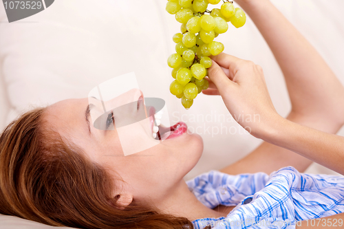 Image of pretty girl with green grapes