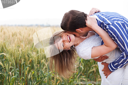 Image of Happy young Couple hugging and kissing eachother