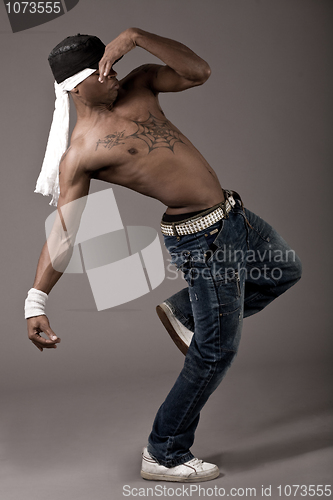 Image of Dancer with spider tatoo on his chest performing dance