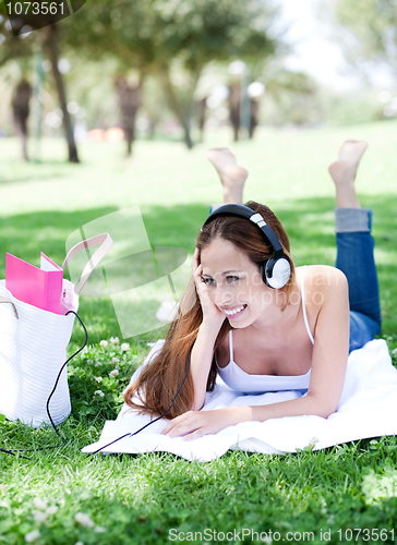 Image of Portrait of a beautiful young lady enjoying music
