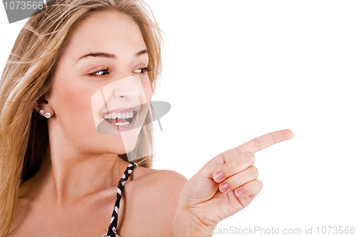 Image of Closeup of young model pointing empty space