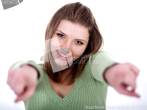 Image of Smiling young female pointing through her both hands