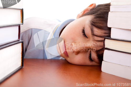 Image of School boy sleeping on table