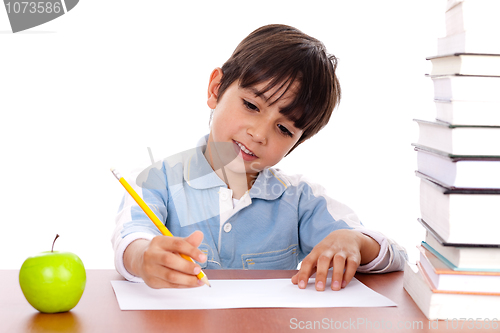 Image of Cute young boy busy in drawing