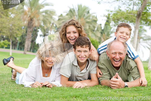 Image of Multi-generation family relaxing in park