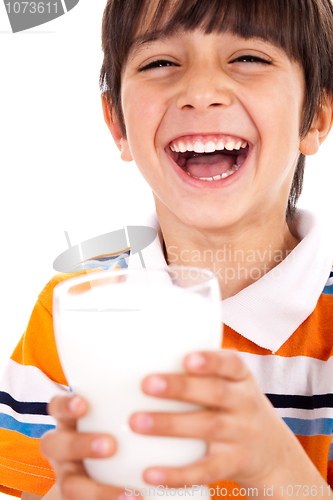 Image of Smiling young boy holding a glass of milk