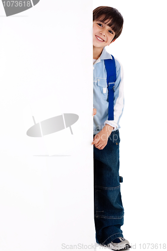 Image of Young kid standing behind the board