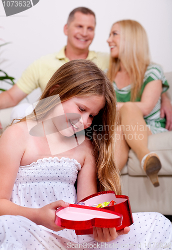 Image of An cute girl happy to see her christmas gift