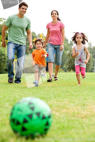 Image of Family playing football in the park