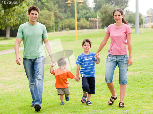 Image of Happy family walking in the park