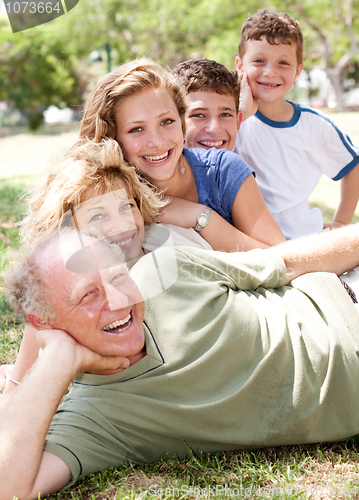 Image of Multi-generation family realxing in park