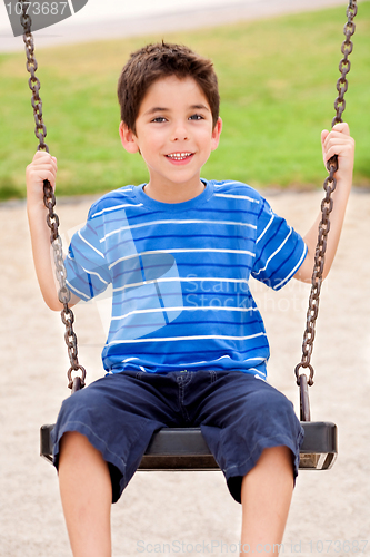 Image of Young kid enjoying swing ride