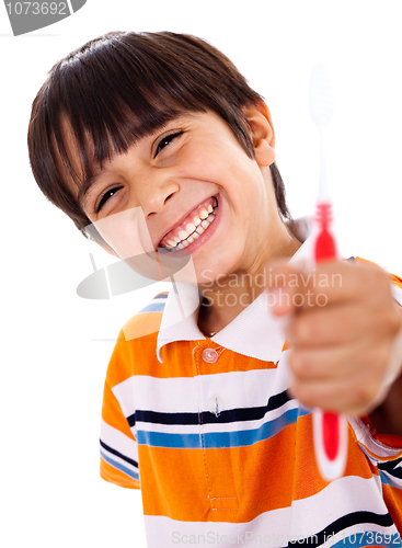Image of Happy young boy showing the toothbrush