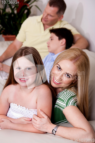 Image of Family of four relaxing at home