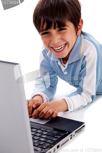 Image of Cute smiling caucasian kid with laptop