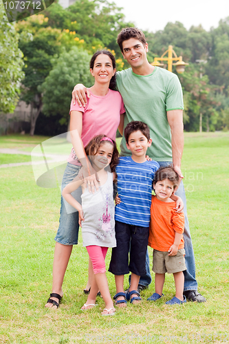 Image of Middle aged couple standing with their children