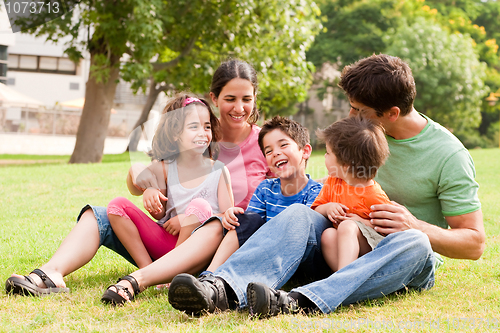 Image of Happy family having fun in the park