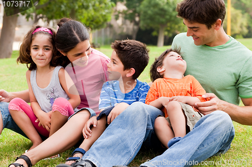 Image of Happy family enjoying summer day in the park