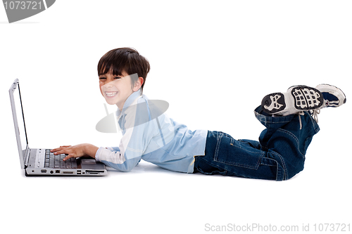 Image of Young boy surfing on his laptop