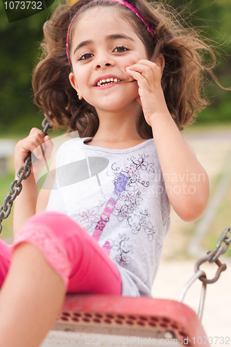 Image of Lovely girl on a swing in the park