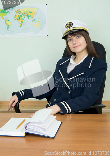Image of Girl in a sea uniform at a table