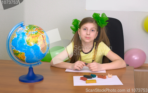 Image of Girl sitting at a table with plasticine