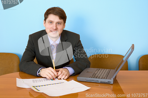 Image of Businessman at a table with laptop