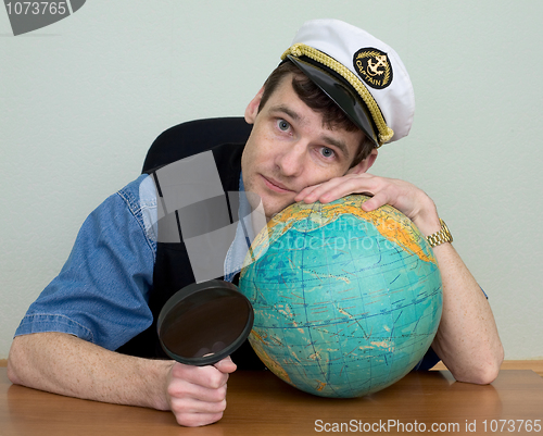 Image of Man in uniform cap with globe
