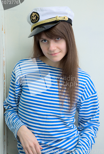 Image of Girl in a cap and a stripped vest