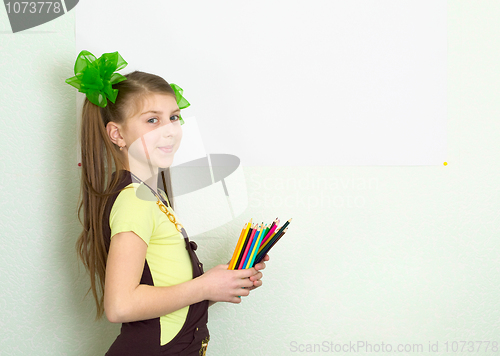 Image of Girl with color pencils and a sheet of paper