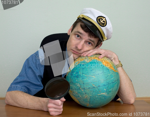 Image of Guy in a sea cap with a globe