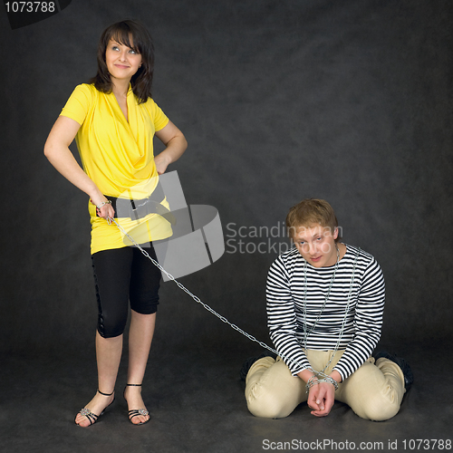 Image of Guy chained in a chain and girl